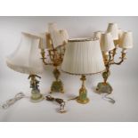 A pair of spelter and onyx five light table lamps, 57cm high, and two other gilt spelter and onyx