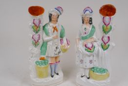 A pair of Staffordshire flat back spill vases modelled as a Scottish lady and gentleman, 27cm high