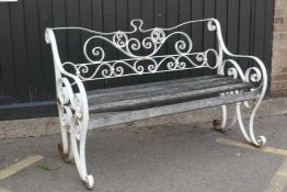 A mid century wrought iron garden seat, the scrolling back monogramed E.R., 144 x 99cms