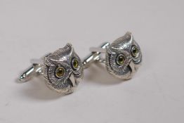 A pair of sterling silver owl head cufflinks