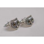 A pair of sterling silver owl head cufflinks