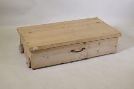 A pine toy box on wooden wheels, 26 x 58 x 53cms