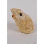 A carved bone okimono in the form of a frog, 6cm high