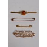 A 10ct yellow gold bar brooch with fine pierced decoration, a 9ct gold brooch set with glass, and