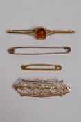 A 10ct yellow gold bar brooch with fine pierced decoration, a 9ct gold brooch set with glass, and
