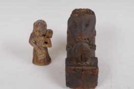 An antique European carved wood votive figure of a lady with bags, 9.5cm high, and an early carved