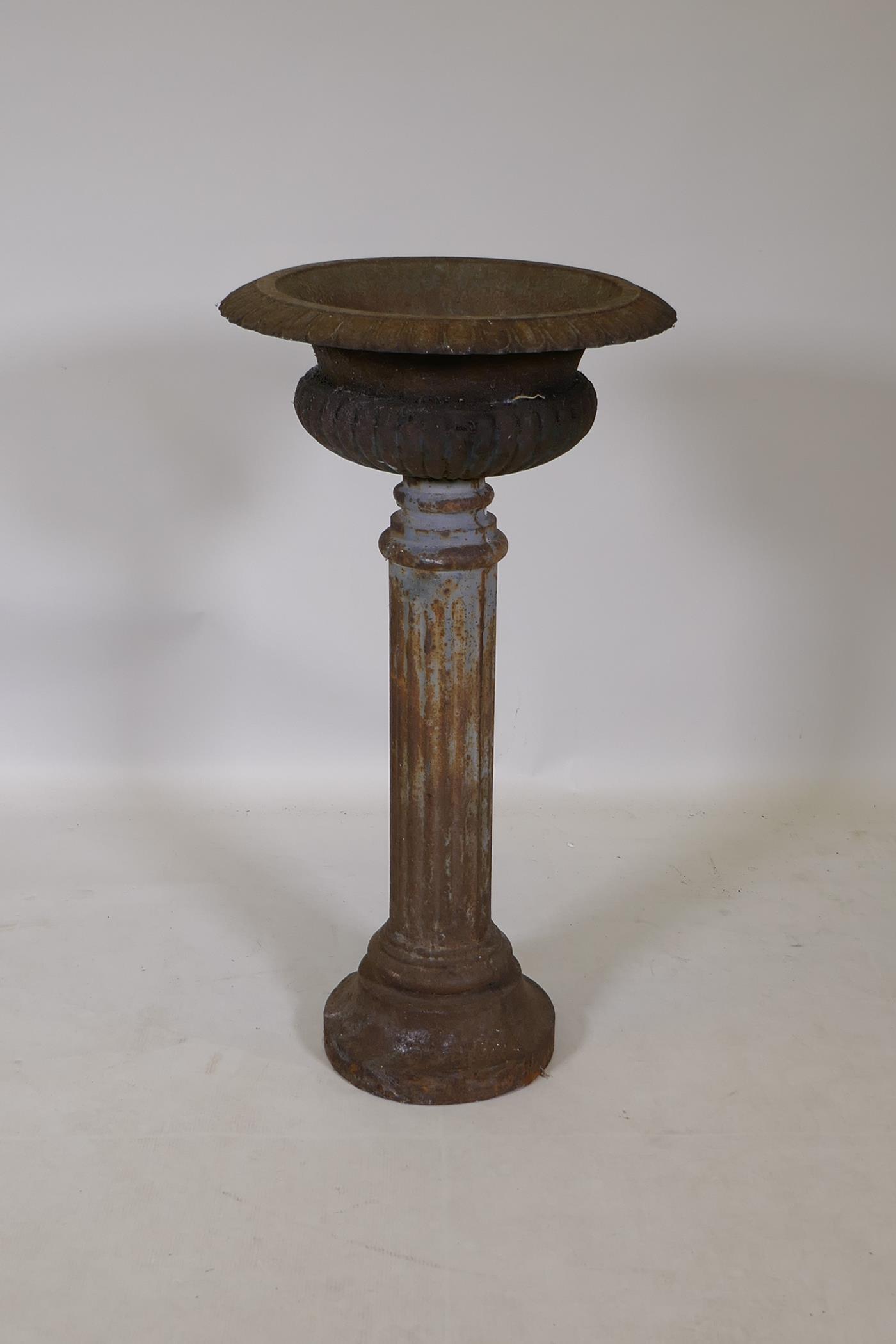 A C19th cast iron pedestal urn, 80cm high