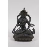 A Sino Tibetan bronze figure of Buddha seated on a lotus throne, 21cm high