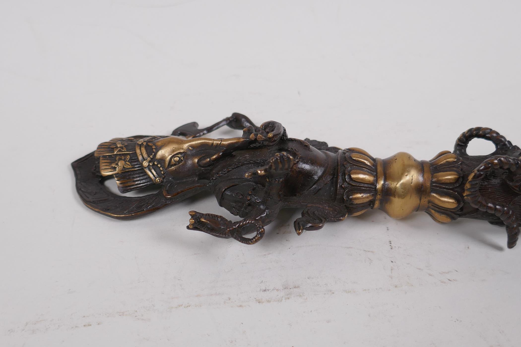 A Tibetan bronzed metal phurba, the handle in the form ofGanesh, 32cm long - Image 4 of 4