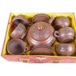 A Chinese Yixing earthenware tea set comprising tea pot, and six cups and saucers