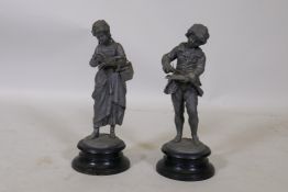 A pair of C19th lead figures, mounted on enamelled metal bases, 33cm high