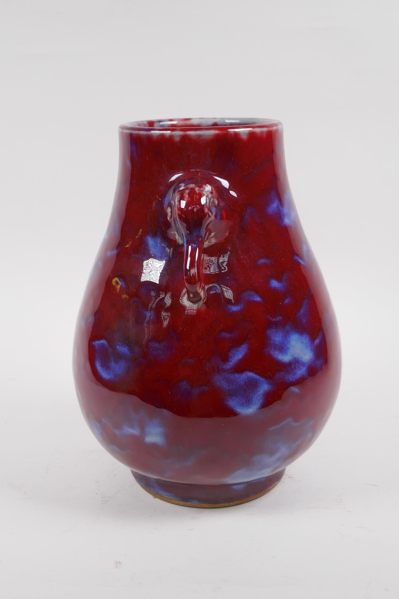 A Chinese blue and red flambe glazed porcelain vase with two elephant mask handles, 27cm high - Image 2 of 5