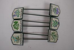 A set of six painted iron herb markers, 27cms long