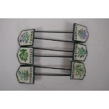 A set of six painted iron herb markers, 27cms long