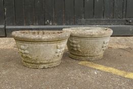 A pair of stone half round planters, 25cm high, 43cm wide