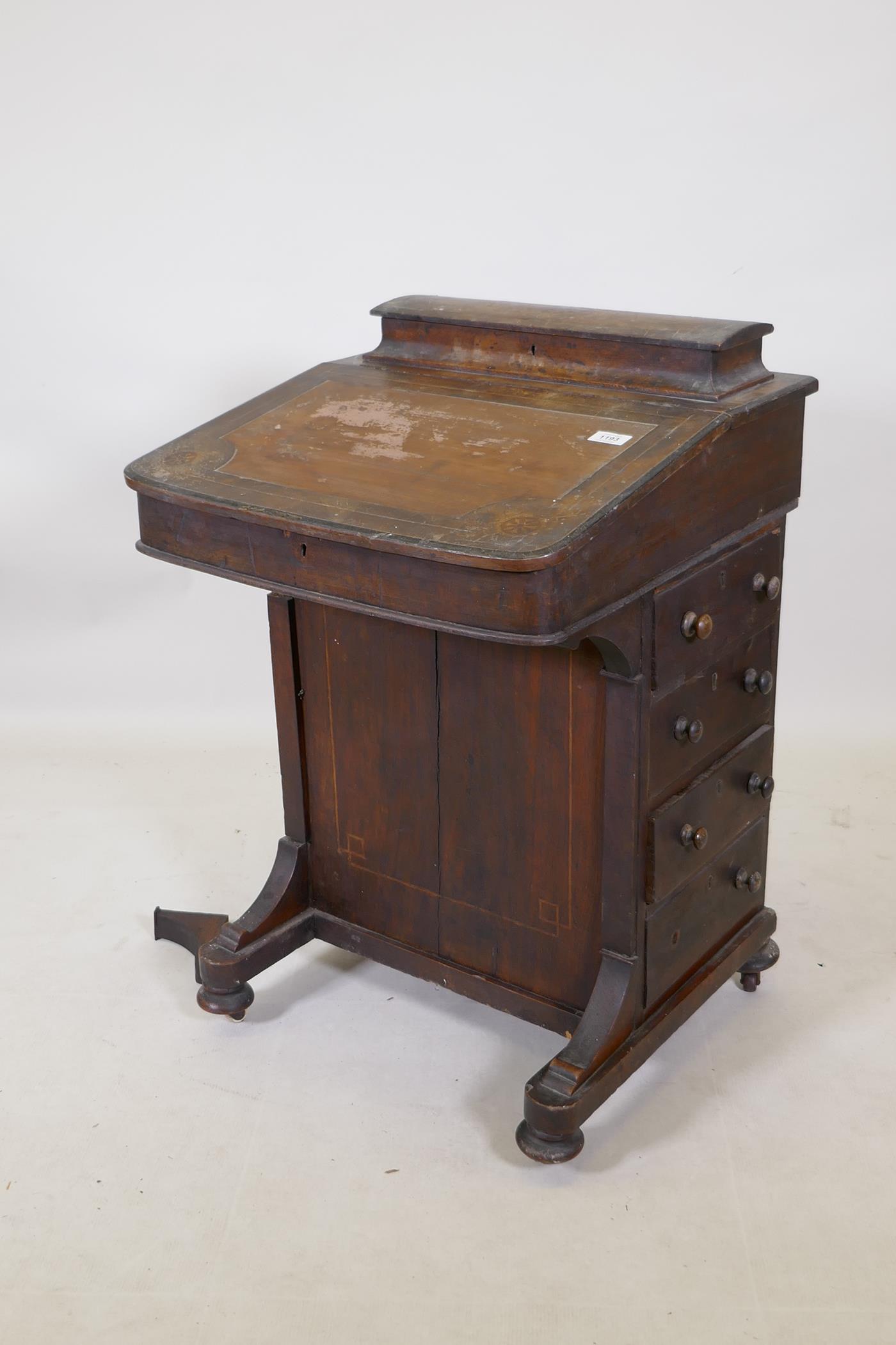 A Victorian inlaid mahogany davenport with four true and four false drawers and lift up top with
