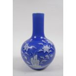 A blue glazed porcelain bottle vase with raised white enamel floral decoration, Chinese Qianlong