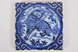A Chinese blue and white porcelain temple tile decorated with kylin, 20 x 20cm