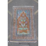 A Persian tan and turquoise ground wood rug with unique thistle design, 124cm x 190cm