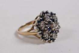 A 9ct yellow gold sapphire and diamond cluster ring, size P