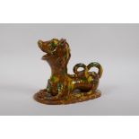 A late C19th/early C20th Turkish canakkale pottery lion, with yellow, green and brown drip glaze,