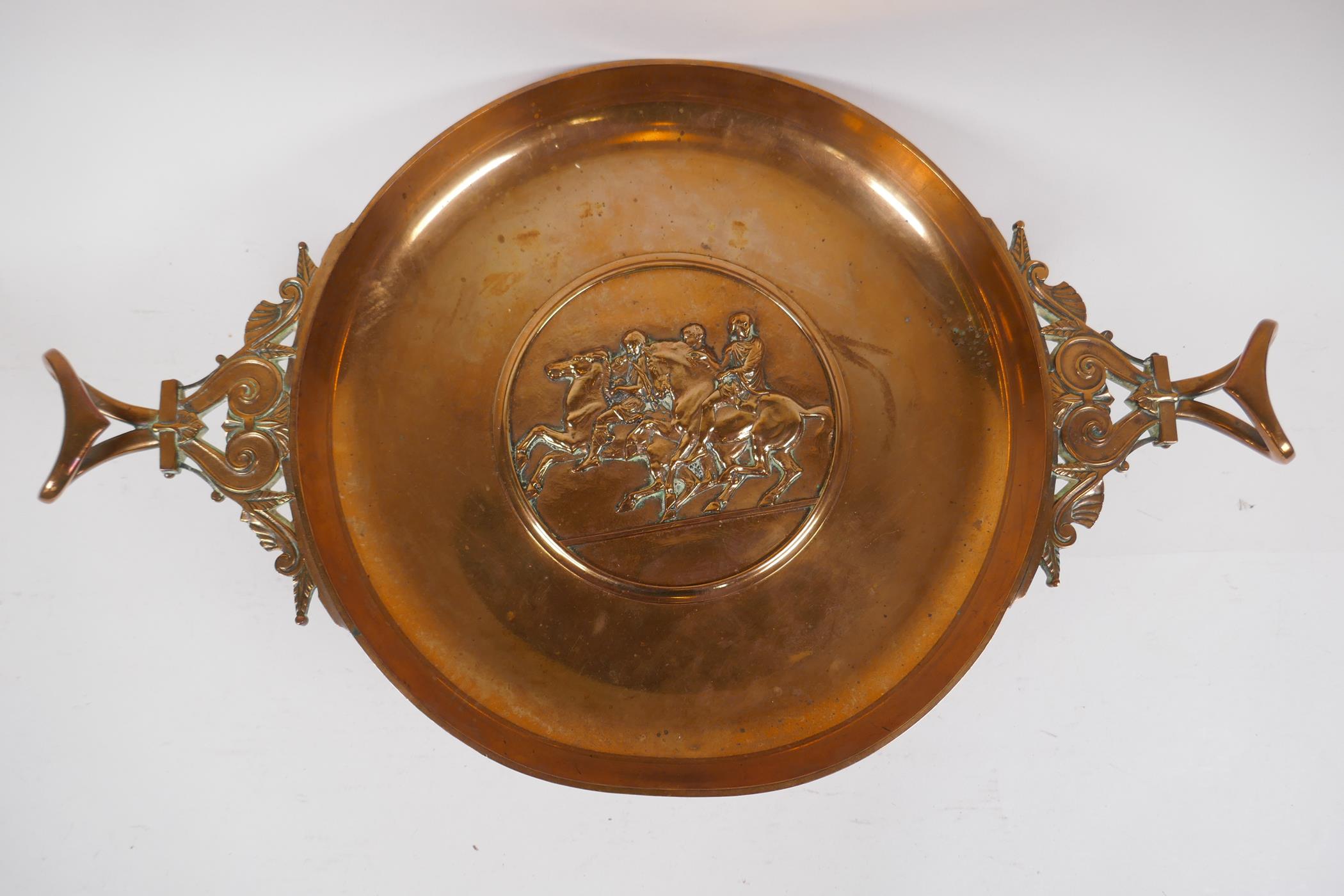 A Barbedienne bronze tazza, the centre embossed with horses and riders, the handles