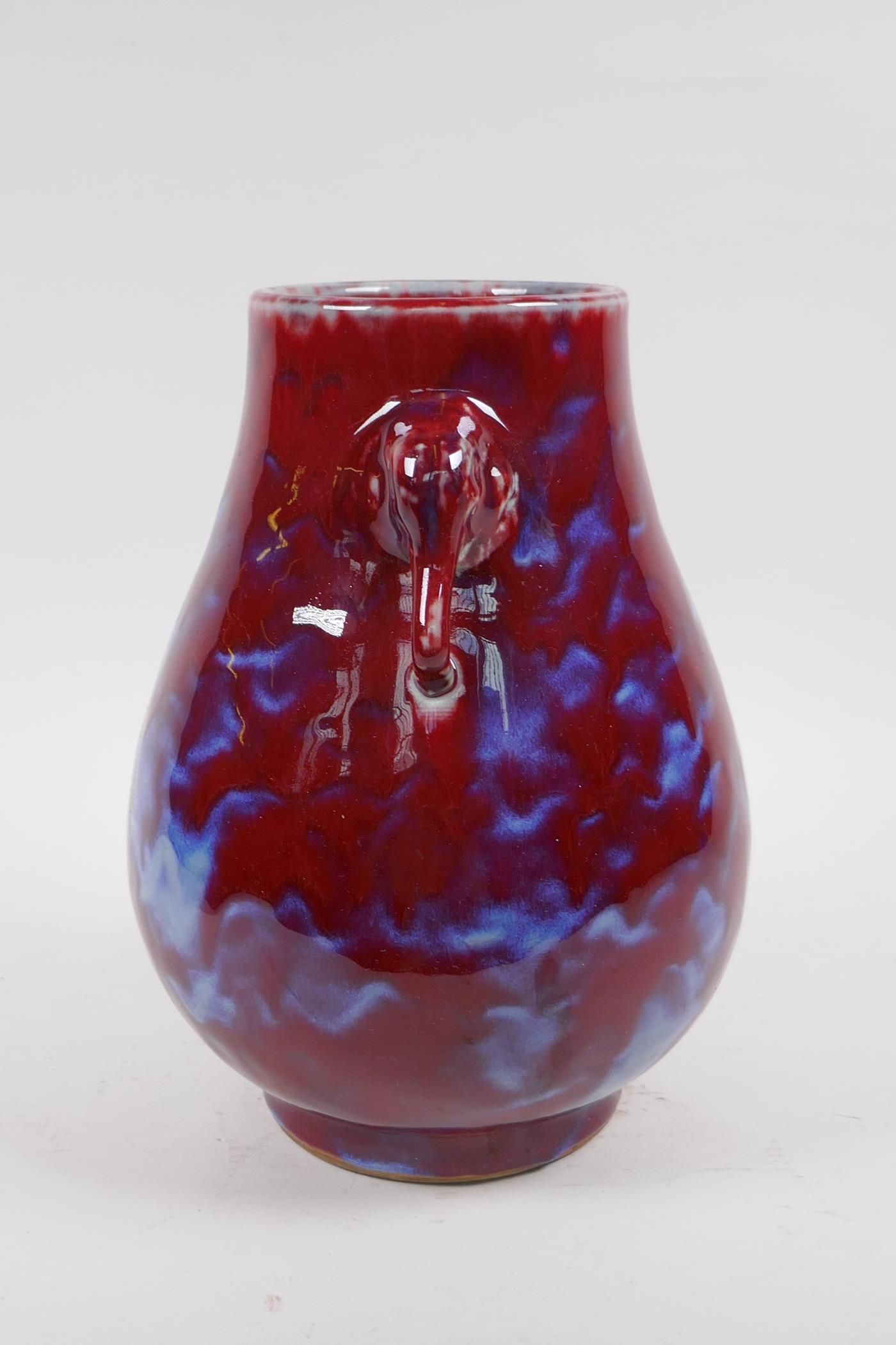 A Chinese blue and red flambe glazed porcelain vase with two elephant mask handles, 27cm high - Image 4 of 5