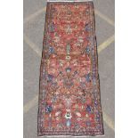 A washed terracotta ground Persian Hamadan runner, with all over floral pattern, 108cm x 284cm