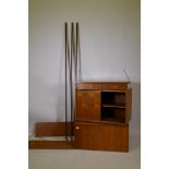A mid century Ladderax teak system, comprising two cabinets and a drawer section, and two shelves,