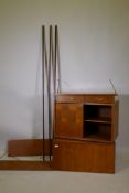 A mid century Ladderax teak system, comprising two cabinets and a drawer section, and two shelves,