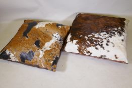 A large cowhide cushion by Cream Designs, London, and another similar, largest 98 x 98cms