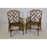 A pair of cane lattice back open arm conservatory chairs