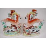 A pair of Staffordshire flat back spill vases modelled as stags and hounds, 29cm high