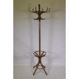 A vintage bentwood hall stand with swivel top and splay supports, 196cm high