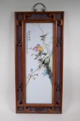 A Chinese Republic style polychrome porcelain panel depicting birds and flowers, in a hardwood