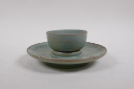 A Chinese Ru ware style celadon glazed tea bowl and saucer with incised petal decoration, 18cm