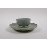 A Chinese Ru ware style celadon glazed tea bowl and saucer with incised petal decoration, 18cm