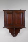 A late C19th oak hanging smoker's cabinet constructed from timbers of H.M.S. Victory, brass plaque