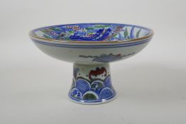 A Chinese Kangxi style blue and white porcelain stem dish with famille vert enamel kylin decoration,