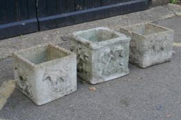 A set of three square section concrete planters embossed with horses, 33cm square