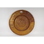 A gilded cast iron wall plaque with classical decoration, 50cm diameter