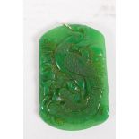 A Chinese green jade pendant carved with a phoenix, and gold ring, 6 x 4cm