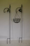 A pair of painted wrought iron garden display stakes and a hanging basket, 199cm