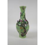 A polychrome porcelain vase with raised peach tree decoration on a green ground, Chinese Qianlong