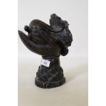 An oriental hardwood carving of a hand bearing a cabbage, 27cm high