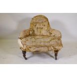 A C19th button back parlour chair on turned supports and brass castors