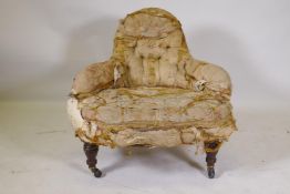 A C19th button back parlour chair on turned supports and brass castors