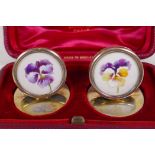 A pair of hallmarked silver menu holders with painted miniatures of flower heads, London 1905,