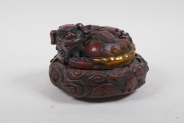 A Chinese bronze censer and cover in the form of a seated kylin with gilt highlights, impressed 4