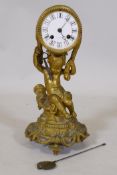 A C19th ormolu mantel clock in the form of putto bearing a drum, the enamel dial with Roman